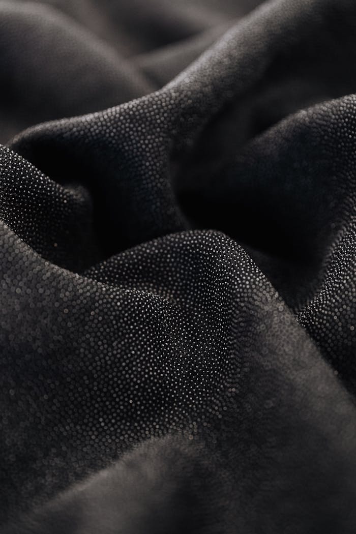 services-02 Detailed view of smooth black fabric revealing texture and folds.